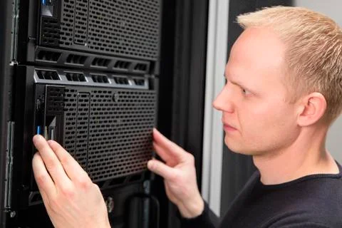 Close-up of It consultant installing server in datacenter Stock Photos
