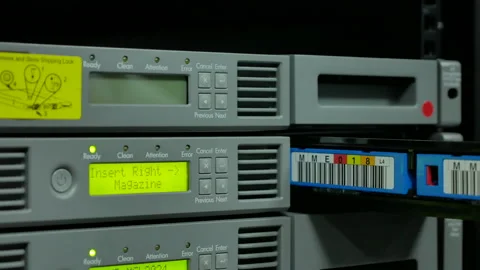 Close up IT engineer inout tape backup slot to tape library. Stock Footage