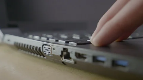Close up of an IT man plugging in an vga cable in the laptop port and unplugg Stock Footage 87014456