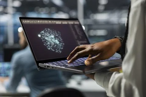 Close up of IT professional in data center using AI LLM assistant on laptop Foto stock