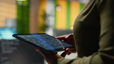 Close up of IT professional in startup office working on tablet with AI Stock Footage 323032503