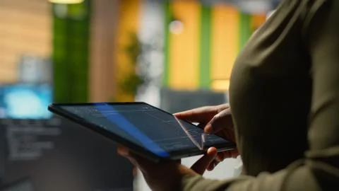 Close up of IT professional in startup office working on tablet with AI Stock Photos
