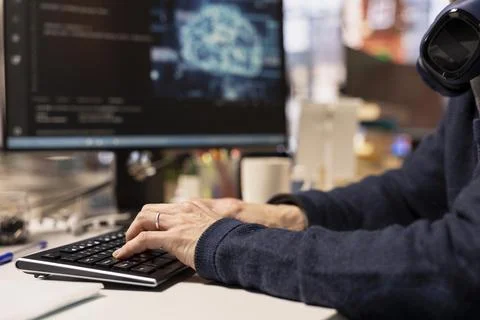 Close up of IT professional using AI machine learning systems on PC Stock Photos