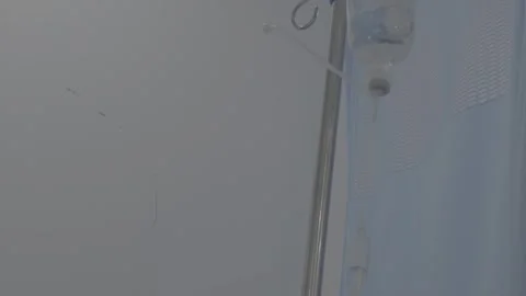 Close-Up of IV Drip Chamber Dripping Saline Solution Stock Footage 345471078