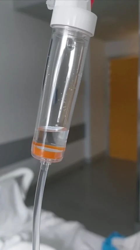 Close-up of IV Drip Chamber with Fluid Dripping in Hospital Room Stockbeeldmateriaal 339322467