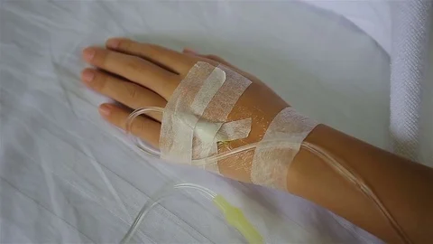 Close up of an iv drip in patient's hand Stock Footage