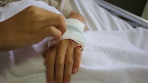 Close up of an iv drip in patient's hand Stock Footage 77295322