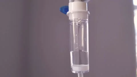 Close up of IV drip Saline dropper dropper with dripping medicine. Drug, death Stock Footage 153621968