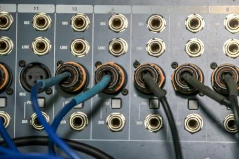 Close up of jack cable connected at rear of switcher sound mixer control panel Stock Photos