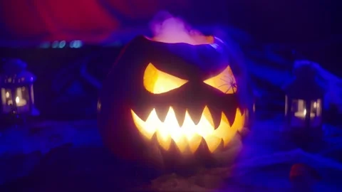 Close-up of a Jack O'Lantern lantern in blue light emitting smoke Stock-Footage 217368905