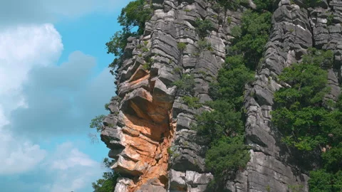 Close-up of Jagged Limestone Cliff Face with Orange Rock Layers in Ha Long Bay Stock Footage 330978343