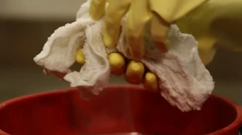 Close-up of janitor squeezing out rag Stock Footage 21624759