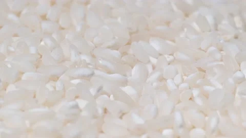Close-up of Japanese raw rice rotating on a plate. White rice video background Stock Footage 225072322