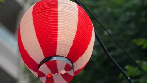 Close-up of Japanese red and white paper lantern swaying in wind Stock Footage 346503167