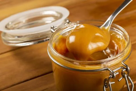 Close-up of jar full of dulce de leche. Dulce de leche, traditional sweet in  Stock Photos