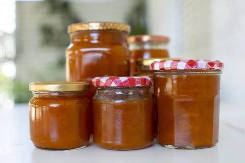 Close up of jars full with apricot jam. Stock Photos