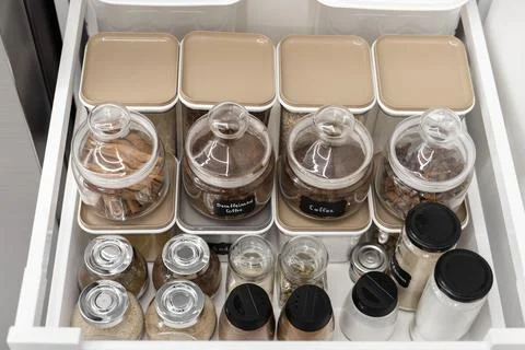 Close-up of jars of spices standing in a kitchen drawer Stock Photos