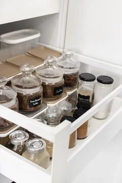 Close-up of jars of spices standing in a kitchen drawer Stock Photos