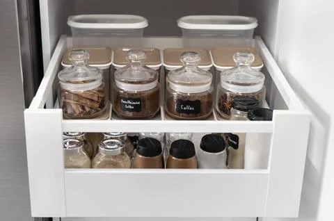 Close-up of jars of spices standing in a kitchen drawer Stock Photos