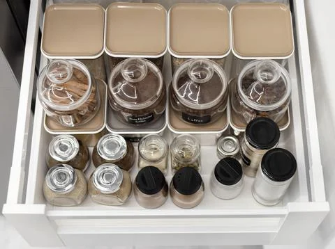 Close-up of jars of spices standing in a kitchen drawer Foto stock