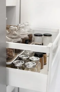 Close-up of jars of spices standing in a kitchen drawer Stock Photos