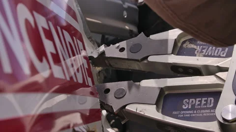 Close up jaws of life being used to open door on car in emergency rescue Stock Footage 331344104