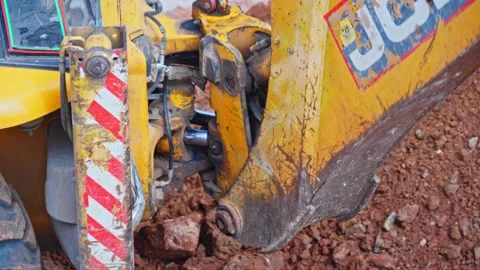 Close-Up of JCB 3dx rear boom swing ram with stabilizer ram at Construction Stock Footage 321848780