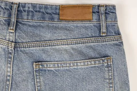 Close-up of jeans from the back on a white background. Blue denim texture. Denim Stock Photos