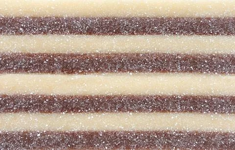 Close up of jelly sheets sprinkled on white background. Jelly sticky sugar. Stock Photos