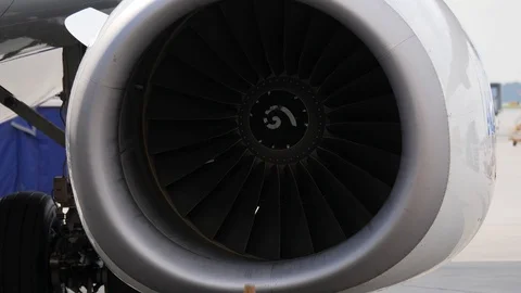 Close up of jet engine. Aircraft with stopped turbines stays on airport ramp Stock Footage 94514060