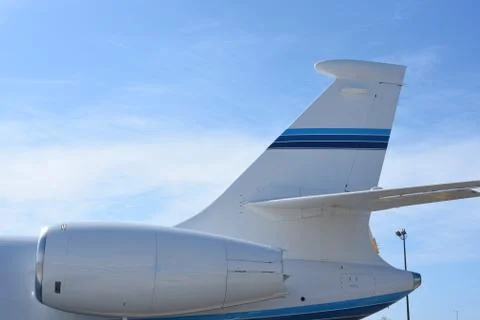 Close up of jet engine and tail of a private jet. Stock Photos