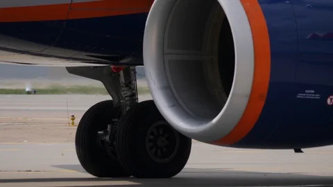 Close up of jet engine. Heat haze from taxiing plane blurs airport apron signs Stock Footage 94513949