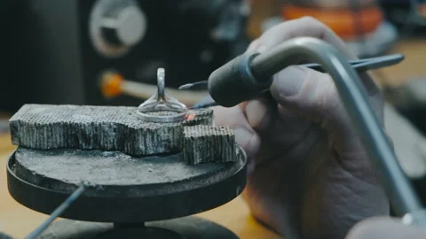 Close up of Jeweler crafting jewelry with flame torch. Stock Footage