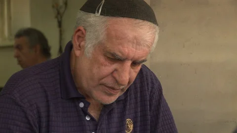 Close Up Of Jewish Man In Cafe Thinking Then Reveal He Is Playing Backgammon Video stock 238646847