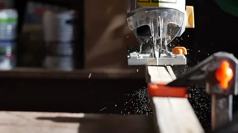 Close up of a jig saw cutting through wood in slow motion. man sawing a wooden Stock Footage 152348274