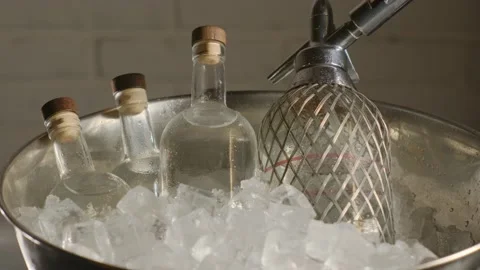 Close-up jin bottles in bucket. Expensive luxurious alcoholic beverage indoors Stock Footage 185026055