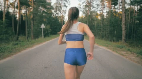 Close up of jogging shoe and legs of jogger. Back side view of a female athlete Stock Footage