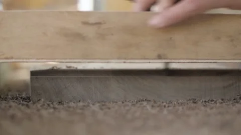 Close-up. A Joinery cuts an old walnut wood plank with an electric hand-held  Stock Footage 137149941