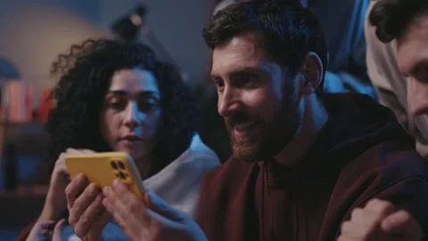 Close up of joyed multiethnic people screaming while watching results of the Stock Footage 168938428