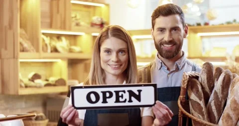 Close up of joyful Caucasian young couple in good mood standing in small own Stock Footage 145154792