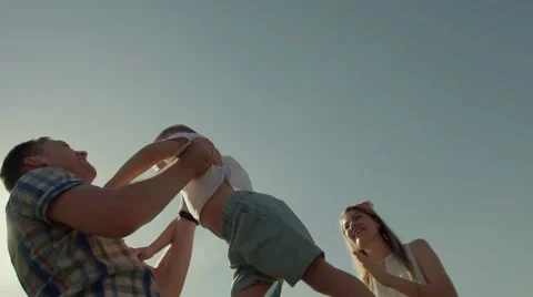 Close-up of joyful father throwing his happy kid in the air against Stock-Footage 68350414