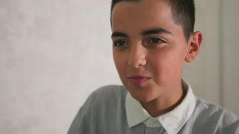 Close-up of joyful young boy making playful expression, smiling and looking Stock-Footage 317929995