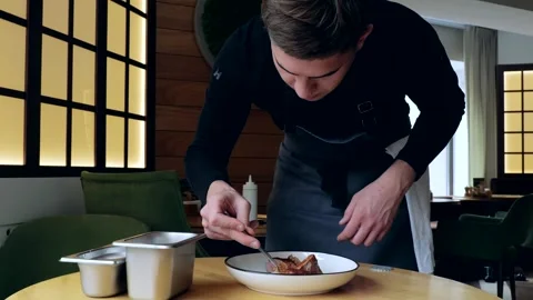 Close-up of a juicy freshly cooked steak. The male cook prepares the composition 스톡 동영상 265257586