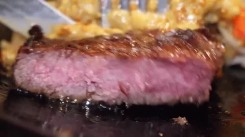 Close Up of Juicy Grilled Beef Steak Being Sliced with Knife Stock Footage 332817600