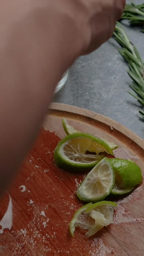 Close-up of a juicy lime being cut with a knife. The process of preparing a Stock Footage 279914952