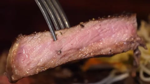 Close-up of a Juicy Medium-Rare Beef Steak Slice on a Fork Video stock 332817534