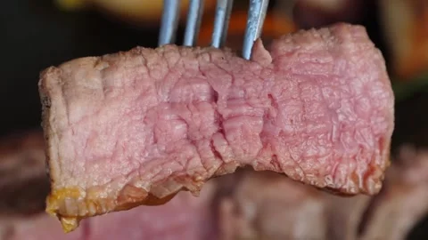 Close-up of Juicy Medium Rare Steak Slice on a Fork Stock Footage 337677669