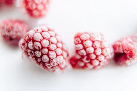 A close-up of a juicy raspberry covered with delicate frost Stock Photos