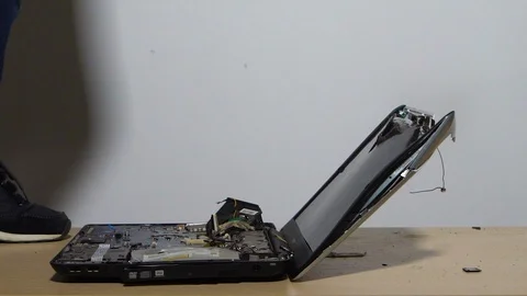 Close-up, a jumping man in slow motion breaks the laptop. 120 frames. Stock-Footage 120016006