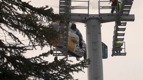 Close-up of Ka-32 helicopter in hover mode next to support of cable car. Stock Footage 106062141